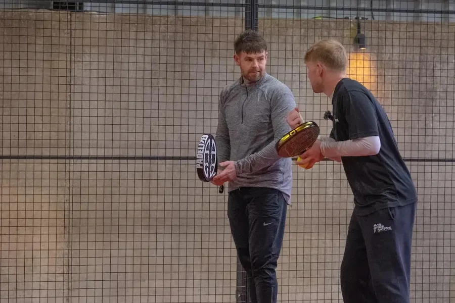 Padel coach giving one-to-one guidance to a player at The Padel Shed Weobley