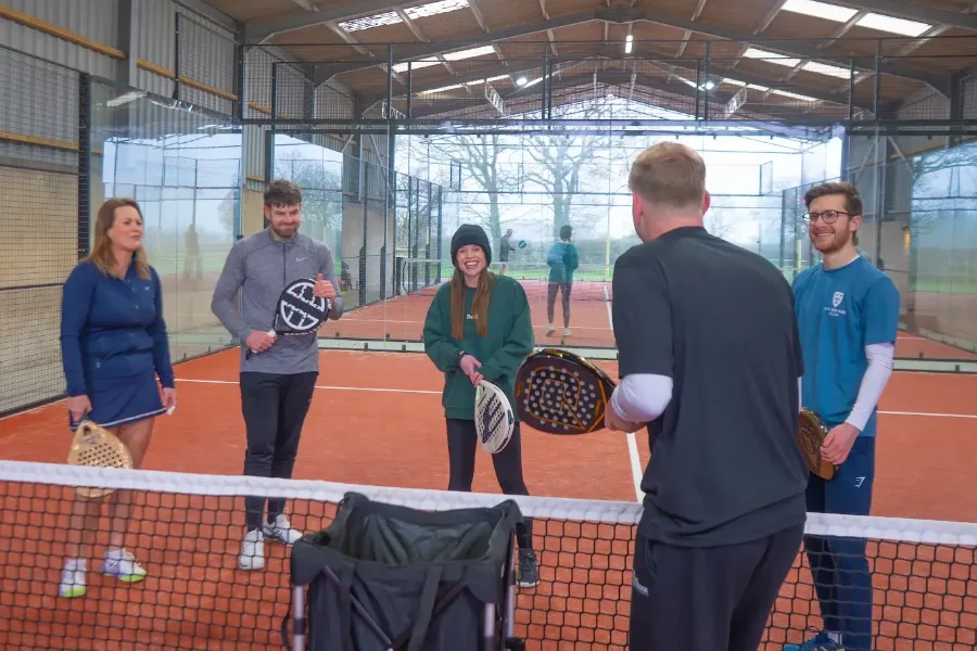 Coach running a group padel coaching session for beginners at The Padel Shed Weobley